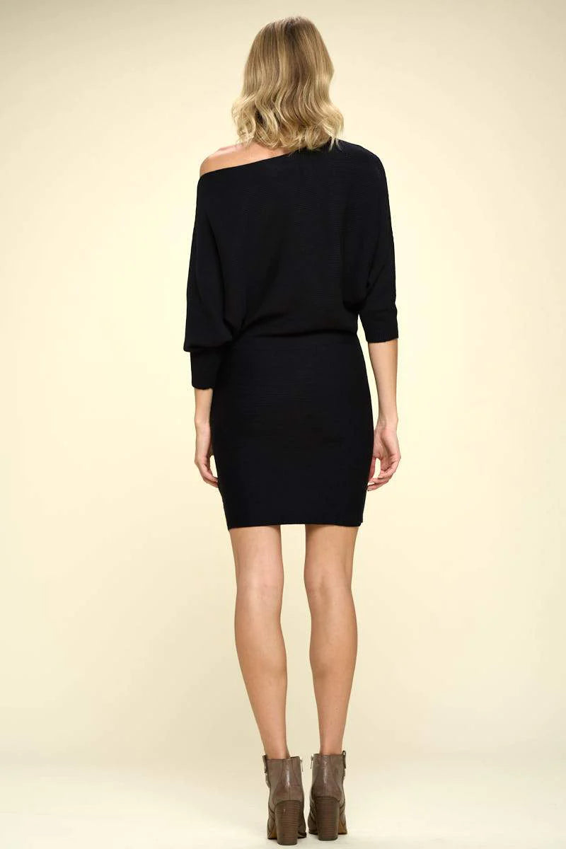 Rear view of a chic black off-the-shoulder ribbed mini dress, showcasing its above-the-knee cut and versatile style for various occasions.