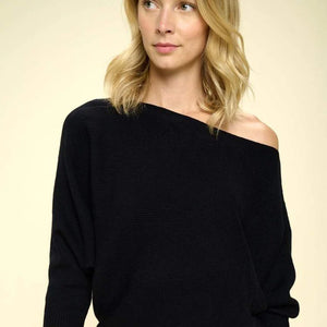 Close-up of a black ribbed knit mini dress with an elegant off-the-shoulder neckline, ideal for cocktail events or a night out.